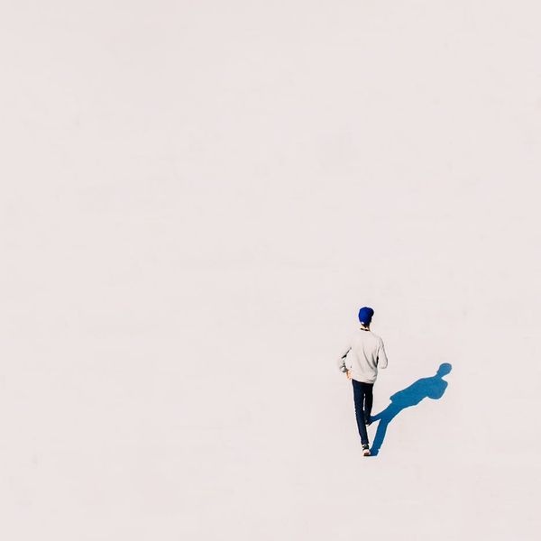 Person meditating calmly with amber accents in a clean space.