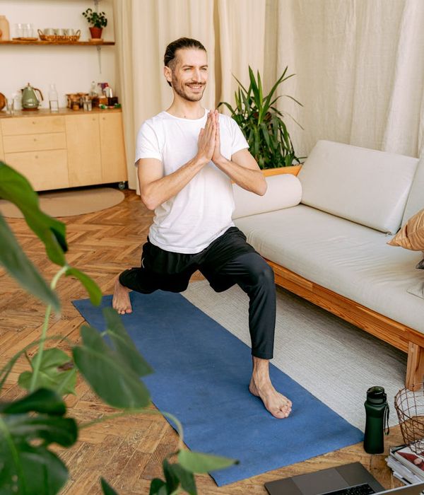 Person smiling, looking refreshed after a fulfilling yoga session.